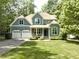 Charming two-story home featuring a well-manicured lawn, attached two-car garage, and a welcoming front porch at 1425 Princess Anne Rd, Cary, NC 27607
