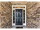 Striking black front door framed by stone and white trim welcomes you home at 1425 Princess Anne Rd, Cary, NC 27607
