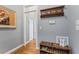 Hallway with shoe rack, hooks, hardwood floors, and view to other rooms at 1425 Princess Anne Rd, Cary, NC 27607