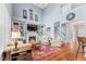 Spacious living room with high ceilings, a fireplace, built-in shelves, and ample natural light at 1425 Princess Anne Rd, Cary, NC 27607