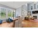 Bright and airy living room with large windows, a wooden table, and open access to the dining area at 1425 Princess Anne Rd, Cary, NC 27607
