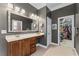 Main bathroom featuring double vanity, tiled floors, and doorway to walk in closet at 1425 Princess Anne Rd, Cary, NC 27607