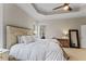 Comfortable main bedroom with neutral walls, tray ceiling, carpeted floors, and two windows at 1425 Princess Anne Rd, Cary, NC 27607