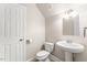 Powder room featuring pedestal sink, standard toilet, and light fixtures at 1425 Princess Anne Rd, Cary, NC 27607