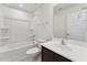 Clean bathroom with a bathtub and shower combination and dark vanity, offering both style and functionality at 1426 Cooper St, Sanford, NC 27330