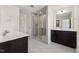 Modern bathroom featuring sleek vanity with dark cabinets and glass enclosed shower with tiled walls at 1426 Cooper St, Sanford, NC 27330