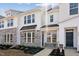 Charming townhome showcasing white siding, stone accents, and an inviting entrance at 1426 Cooper St, Sanford, NC 27330