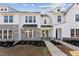 Townhome exterior featuring a combination of stone and siding, complemented by well-kept landscaping at 1426 Cooper St, Sanford, NC 27330