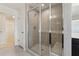 Close up of a tiled shower with glass door and built-in bench in modern bathroom at 1426 Cooper St, Sanford, NC 27330