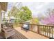 Back deck featuring a blue bench and seating with a wooden railing and a view of the backyard at 1426 N Roxboro St, Durham, NC 27701
