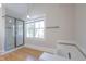 A bathroom featuring tile accents, hardwood floors, and a glass-enclosed shower at 1426 N Roxboro St, Durham, NC 27701