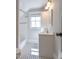 Classic bathroom with white subway tile, a vanity with storage, and a window for natural light at 1426 N Roxboro St, Durham, NC 27701