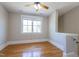 A bedroom features hardwood floors, a ceiling fan, and a window for natural light at 1426 N Roxboro St, Durham, NC 27701