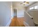 A bedroom with hardwood floors and view to additional rooms through doorway at 1426 N Roxboro St, Durham, NC 27701