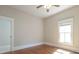 A bedroom features hardwood floors, a ceiling fan, and a window for natural light at 1426 N Roxboro St, Durham, NC 27701