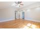 Spacious room featuring a ceiling fan, hardwood floors, and neutral walls at 1426 N Roxboro St, Durham, NC 27701