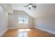 Bedroom with ceiling fan, large window and hardwood floors at 1426 N Roxboro St, Durham, NC 27701