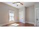 A bedroom with hardwood floors, a ceiling fan, neutral paint and plenty of natural light at 1426 N Roxboro St, Durham, NC 27701