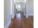 Inviting hallway with hardwood floors and white trim, creating a seamless flow between rooms and spaces at 1426 N Roxboro St, Durham, NC 27701