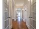 A home hallway with hardwood floors and glass-paneled doors leading to other rooms at 1426 N Roxboro St, Durham, NC 27701