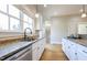 Bright kitchen with stainless steel dishwasher, a large window, and granite countertops for a stylish cooking experience at 1426 N Roxboro St, Durham, NC 27701