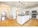 Modern kitchen featuring a center island, stainless appliances, granite counters and hardwood flooring for an amazing look at 1426 N Roxboro St, Durham, NC 27701