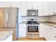 Modern kitchen with stainless steel appliances, granite countertops, and ample cabinet space for easy meal prep at 1426 N Roxboro St, Durham, NC 27701