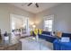 Open living space featuring a blue sofa, hardwood floors, and an inviting atmosphere with abundant natural light at 1426 N Roxboro St, Durham, NC 27701