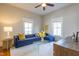 Comfortable living room featuring a plush sofa, a glass coffee table, and bright natural light at 1426 N Roxboro St, Durham, NC 27701