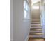 A bright staircase with hardwood steps, white risers, and natural light from a window at 1426 N Roxboro St, Durham, NC 27701