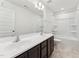Bathroom showcasing a dual sink vanity, complemented by a bathtub with a shower at 1430 Cooper St, Sanford, NC 27330
