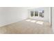 Sunny bedroom with neutral carpet, three large windows, and ample natural light, creating a serene atmosphere at 1430 Cooper St, Sanford, NC 27330