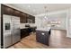Well-lit kitchen featuring stainless steel appliances, a center island, and an open layout leading to other living spaces at 1430 Cooper St, Sanford, NC 27330