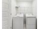Convenient laundry area with washer and dryer, plus shelving for storage at 1430 Cooper St, Sanford, NC 27330