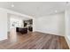 Spacious living room with modern hardwood flooring and an open layout leading to the kitchen at 1430 Cooper St, Sanford, NC 27330