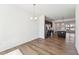 Open-concept living area with a dining area, hardwood floors, stainless steel appliances, and island with a sink at 1430 Cooper St, Sanford, NC 27330