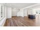 Open-concept living area with hardwood floors, a staircase, and a kitchen island, creating a welcoming space at 1430 Cooper St, Sanford, NC 27330