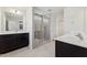 Bathroom with a glass shower, dark cabinets, and a double sink at 1432 Cooper St, Sanford, NC 27330