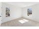 Light filled bedroom with neutral carpet and two windows at 1432 Cooper St, Sanford, NC 27330