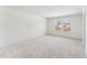 Bright bedroom with neutral carpet and two windows bringing in natural light at 1432 Cooper St, Sanford, NC 27330