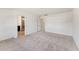 Spacious bedroom with neutral carpet; bathroom and closet accessible via doors at 1432 Cooper St, Sanford, NC 27330