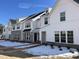 Townhomes with a mix of white siding, stone, driveways and fresh landscaping are ready to be enjoyed at 1432 Cooper St, Sanford, NC 27330