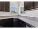 Modern kitchen features granite counters, dark cabinets and a stainless steel sink at 1432 Cooper St, Sanford, NC 27330