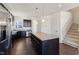 Modern kitchen featuring stainless steel appliances, dark cabinets, and a granite island at 1432 Cooper St, Sanford, NC 27330