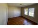 Bedroom featuring natural light from windows and hardwood flooring, providing a calm and inviting space at 148 Baptist Church Rd, Henderson, NC 27537