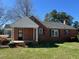 Charming one-story red brick home with a welcoming front porch and well-manicured lawn at 148 Baptist Church Rd, Henderson, NC 27537