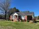Charming brick home with a well-manicured lawn and beautiful landscaping at 148 Baptist Church Rd, Henderson, NC 27537