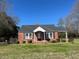 Charming one-story red brick home with a welcoming front porch and well-manicured lawn at 148 Baptist Church Rd, Henderson, NC 27537