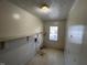 Small laundry room with a window and a utility shelf at 148 Baptist Church Rd, Henderson, NC 27537