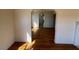Open living room with hardwood flooring, white walls, and fireplace at 148 Baptist Church Rd, Henderson, NC 27537